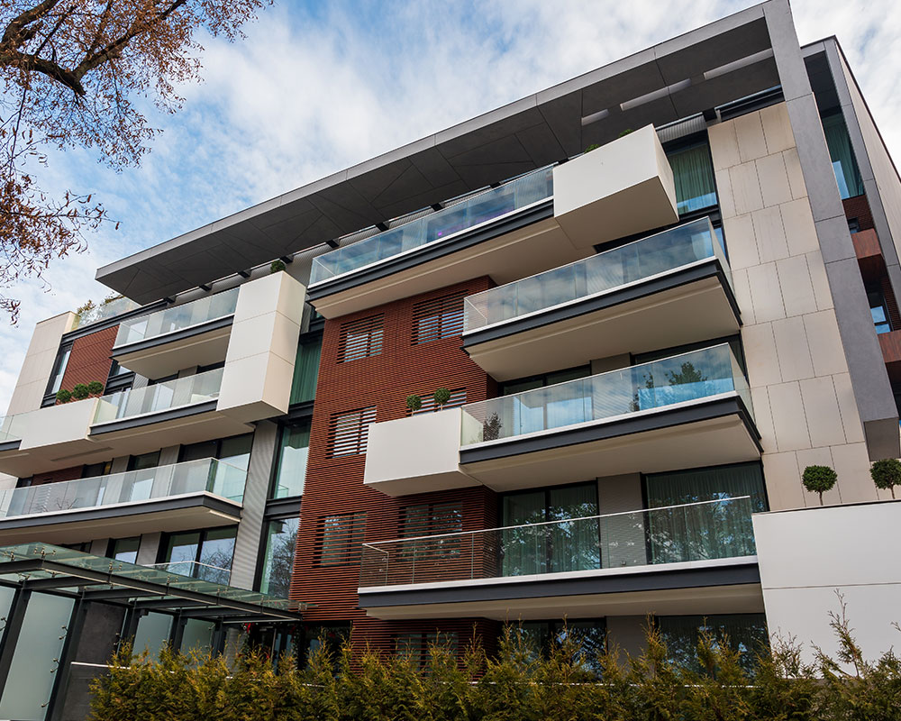 The exterior of a modern, multi-story apartment building available at Baudin Beach.